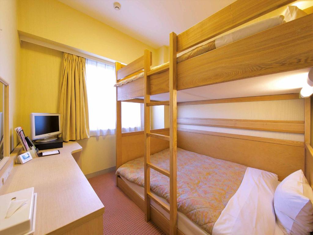 A room with yellow-framed bunk beds