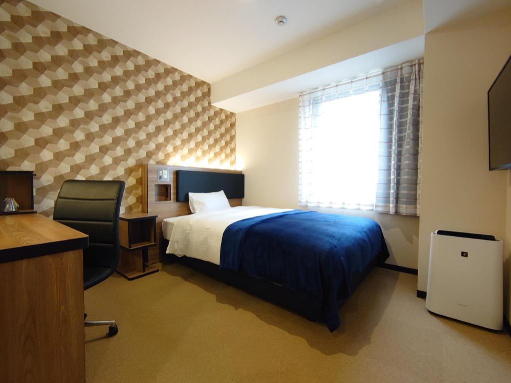 Beds or bedding in a real guestroom at Green Rich Hotel Yonago Ekimae