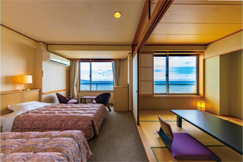 Beds or bedding in a real guestroom at Kaike Grand Hotel Tensui