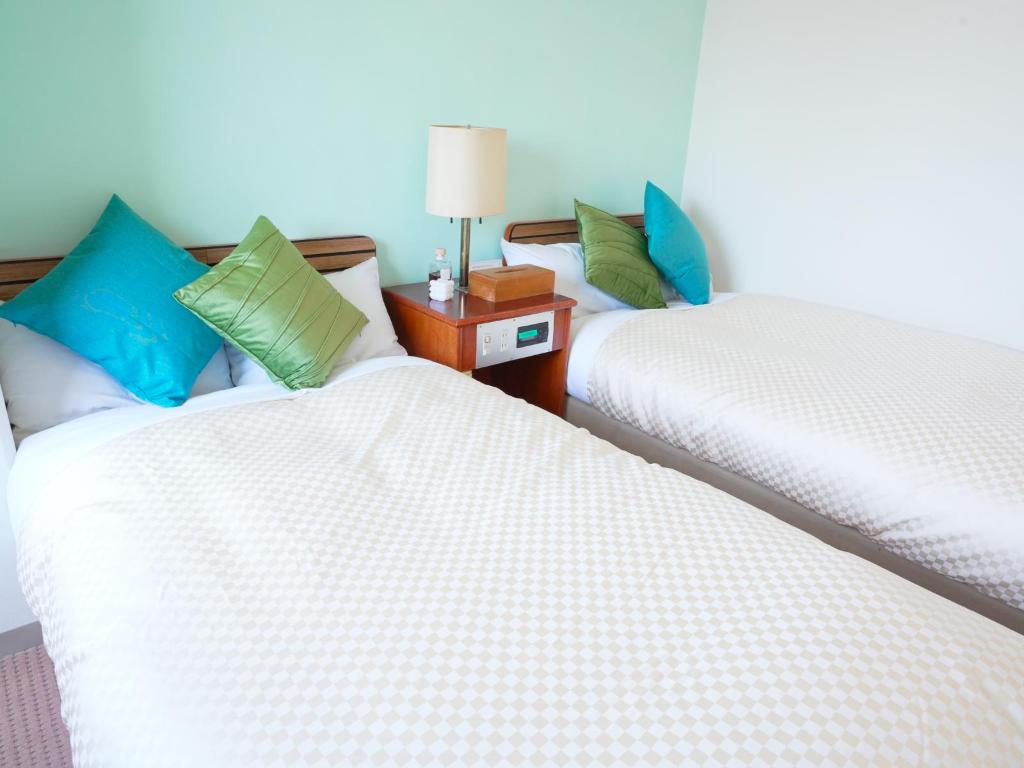 Beds or bedding in a real guestroom at Green Hotel Yonago