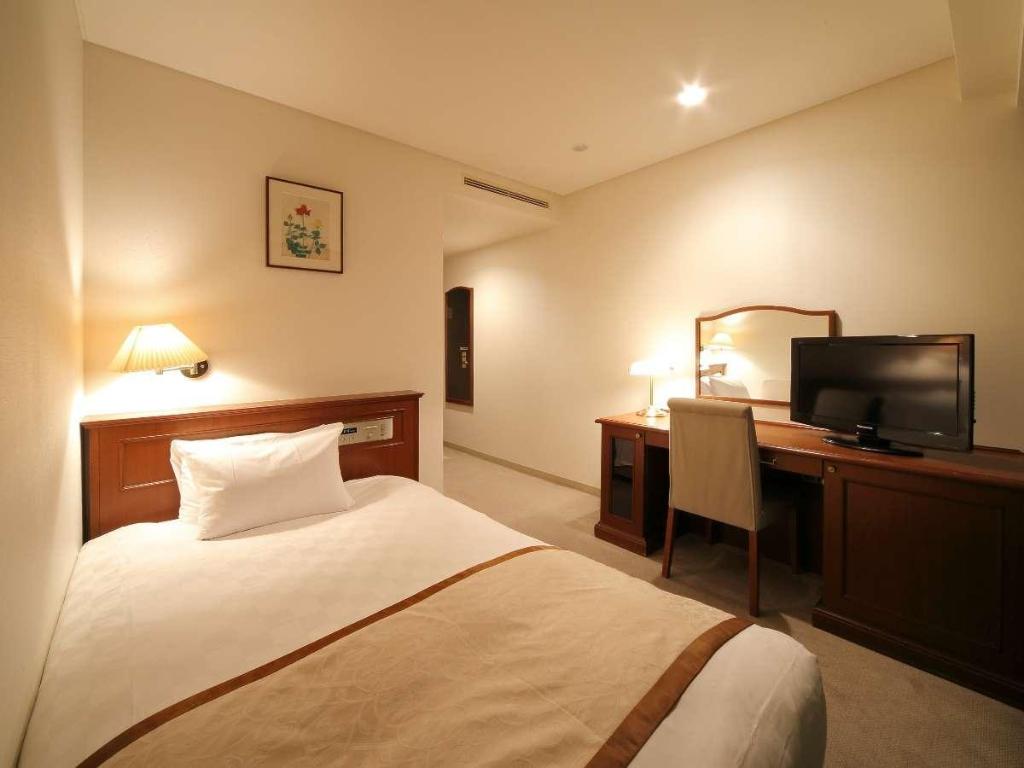 Beds or bedding in a real guestroom at Hotel Harvest In Yonago