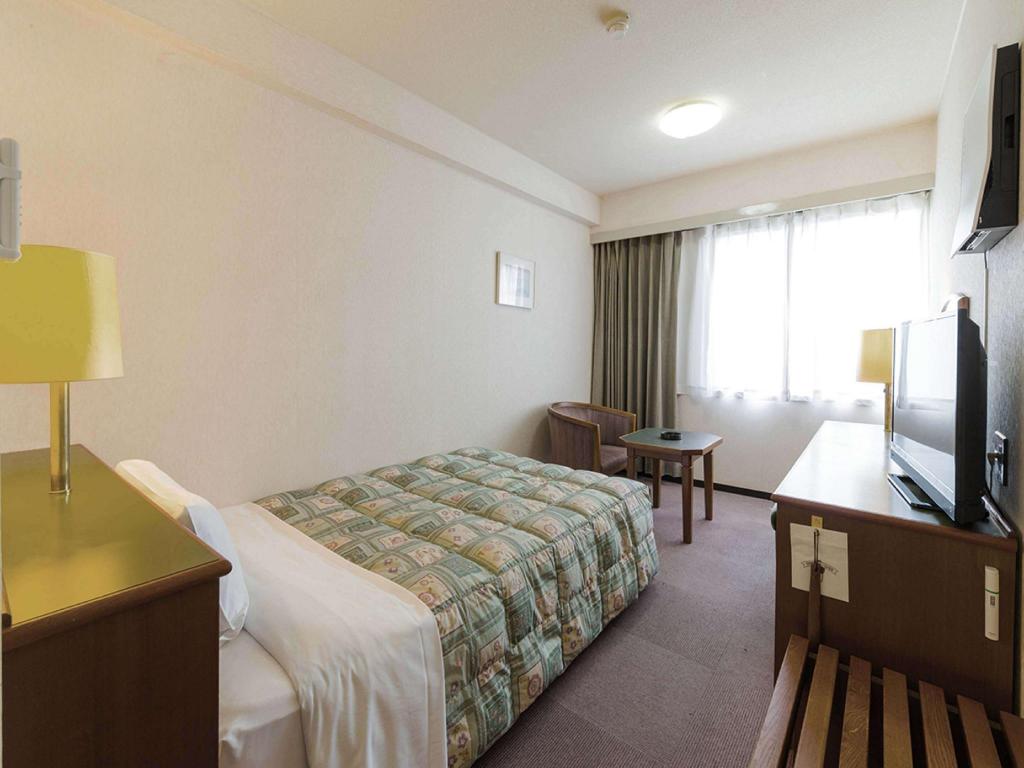Beds or bedding in a real guestroom at Yonago New Urban Hotel