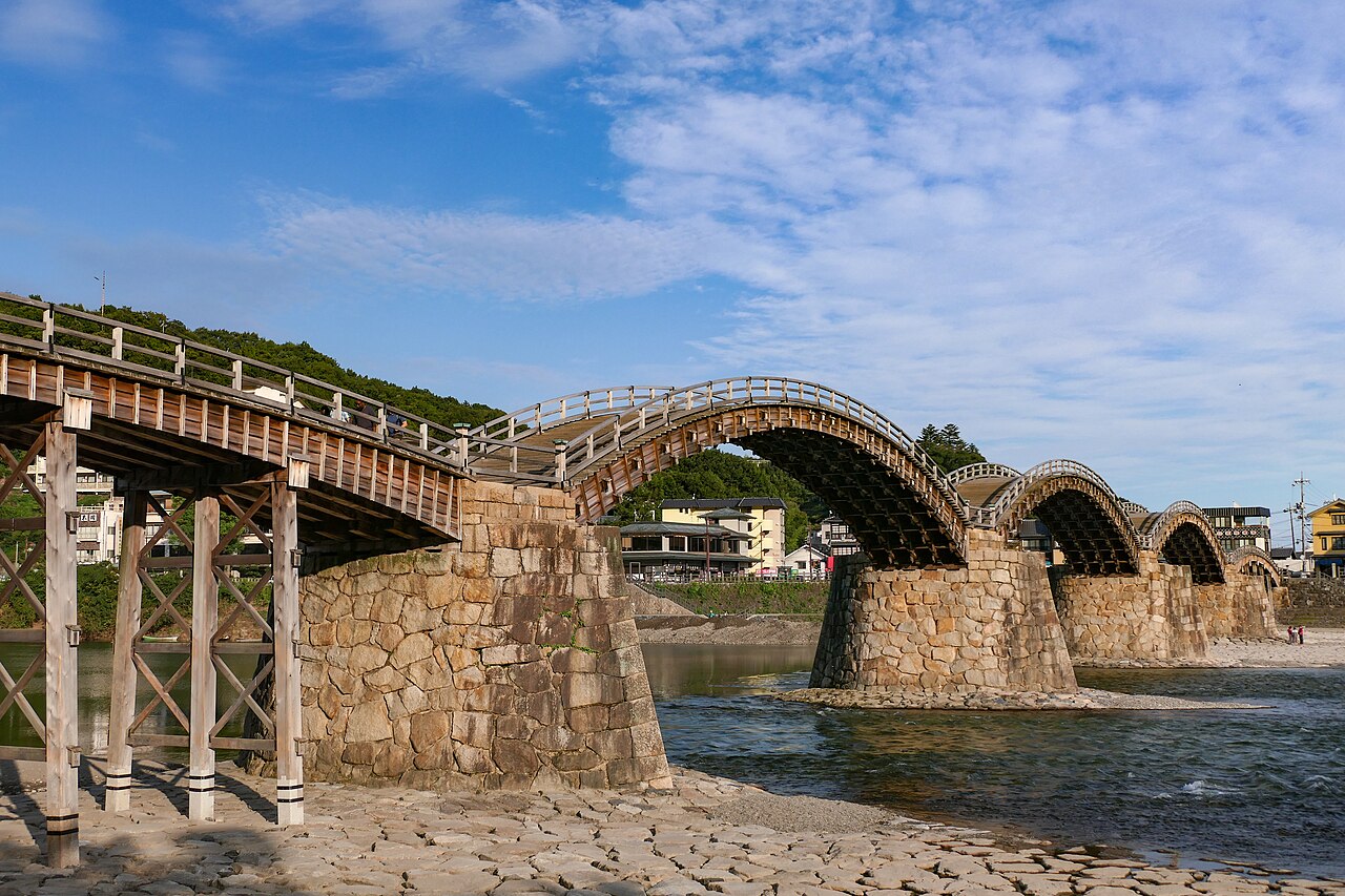 Wooden arches and stone piers of Kintaikyo Bridge over the Nishiki River