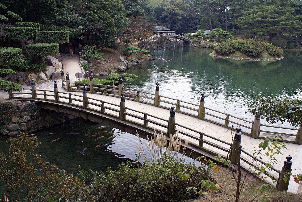 Bridge, koi and a pine-lined pond at Ritsurin Garden