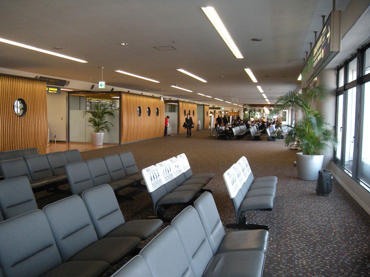 Historic boarding lounge at Miyazaki Airport with window seats and plants