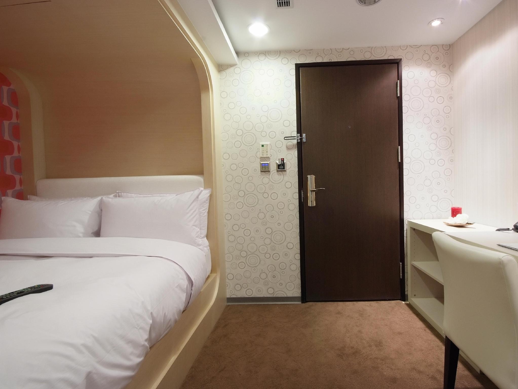 Hotel Leisure Taichung: 침대·베개·출입문·책상이 보이는 객실