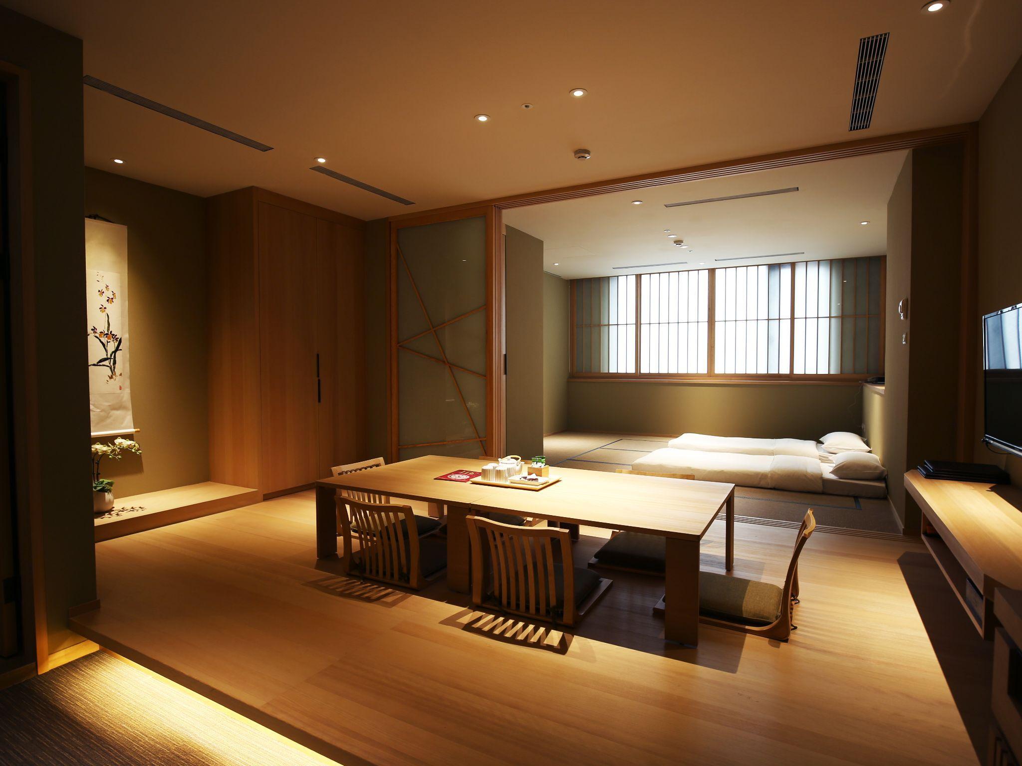 Maison De Chine Hotel: A Japanese-style room with two sets of floor bedding in a rear alcove and a low table
